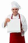 Young Chef Looking At Delicious Pizza Stock Photo