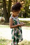 Young Child Using Smartphone At Park Stock Photo