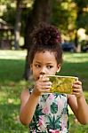 Young Child Using Smartphone At Park Stock Photo