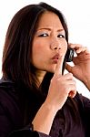 Young Corporate Woman Talking On Cell Phone And Shushing Stock Photo