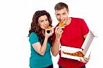 Young Couple Eating Pizza Stock Photo