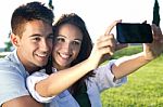 Young Couple Having Fun In A Park Stock Photo