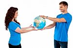 Young Couple Holding Globe Together Stock Photo