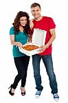 Young Couple Holding Pizza Box Stock Photo