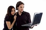 Young Couple Looking Into Laptop Stock Photo