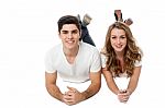 Young Couple Lying On The Floor Stock Photo