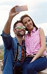 Young Couple Of Tourist In Town Using Mobile Phone Stock Photo