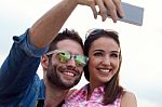 Young Couple Of Tourist In Town Using Mobile Phone Stock Photo