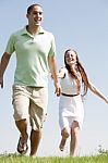 Young Couple Running Stock Photo