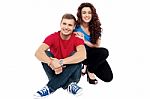 Young Couple Sitting On Floor Stock Photo