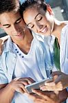 Young Couple Using A Digital Tablet Stock Photo