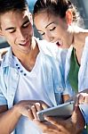 Young Couple Using A Digital Tablet Stock Photo