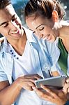 Young Couple Using A Digital Tablet Stock Photo