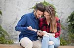 Young Couple Using Smart Phone Stock Photo