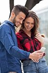 Young Couple Using Smart Phone Stock Photo