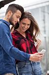 Young Couple Using Smart Phone Stock Photo