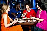 Young Couples Enjoying Their Dinner With Drinks Stock Photo