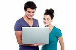 Young Couples Holding Laptop Stock Photo