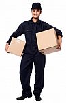 Young Courier Boy Holding Parcels Stock Photo