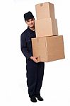 Young Courier Guy Moving Boxes Stock Photo