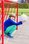 Young Crouching Girl With Ball On Hands In Metall Goal Stock Photo