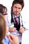 Young Doctor Sitting With Hospital Staff Stock Photo