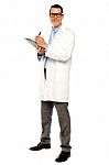 Young Doctor Writing Medical Report Stock Photo