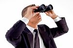 Young Executive Observing Through Binoculars Stock Photo