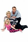 Young Family Of Three Posing Indoors. Studio Shot Stock Photo