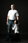 Young Family Posing Standing In Studio Stock Photo