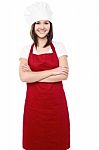 Young Female Chef With Folded Arms Stock Photo