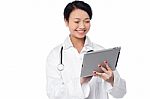 Young Female Doctor Holding A Tablet Stock Photo