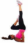 Young Female Doing Exercise, Stretching Her Leg Stock Photo