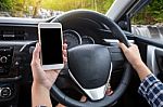 Young Female Driver Using Touch Screen Smartphone And Hand Holdi Stock Photo