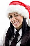 Young Female Winking Eyes And Wearing Christmas Hat Stock Photo