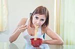 Young Girl Eating Ramen Noodles Stock Photo