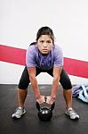 Young Girl Lifting Kettlebell Stock Photo