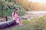 Young Girl Reading A Book In The Park Stock Photo