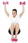 Young Girl Sitting On Floor And Doing Fitness Exercise Stock Photo