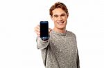 Young Guy Displaying Brand New Cellphone Stock Photo