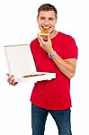 Young Guy Eating Pizza Stock Photo