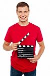 Young Guy Holding Clapperboard Stock Photo