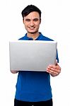 Young Guy Holding Laptop Stock Photo