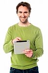 Young Guy Operating Tablet Device Stock Photo