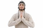 Young Guy Praying With Woolly Hat Stock Photo