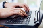 Young Handsome Man Working In His Office With Laptop Stock Photo