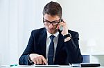 Young Handsome Man Working In His Office With Mobile Phone Stock Photo