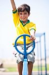 Young Kid Enjoying Swing Ride Stock Photo