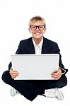 Young Kid Sitting On Laptop Stock Photo