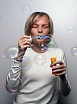 Young Lady Blowing Bubbles Stock Photo